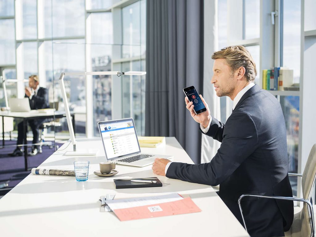 Businessman dictating using a mobile device